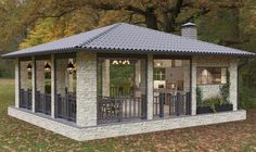 a gazebo in the middle of a park with tables and chairs on top of it