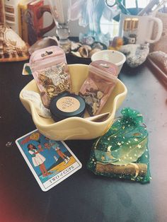 a bowl filled with lots of different items on top of a table next to cards