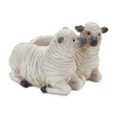 two ceramic sheep sitting next to each other