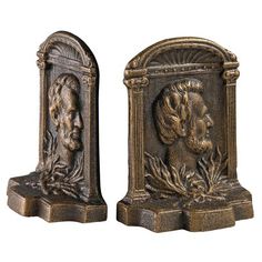 pair of antique bronzed bookends with heads of men and women on them