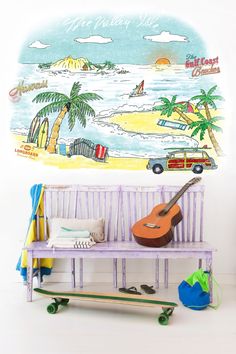 a wooden bench with a guitar on it in front of a wall mural that says the beach side