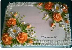 a cake decorated with orange and white flowers