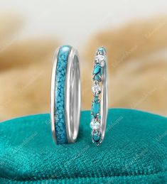 two wedding rings with blue and white stones