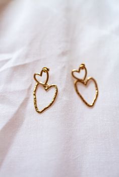 Elevate your style with our golden earrings adorned with two charming stainless steel hearts. These earrings seamlessly marry strength and romance, making them a meaningful and enduring addition to your jewelry collection.