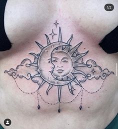 a woman's chest with a sun and moon tattoo on it