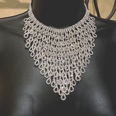 This is an absolutely STUNNING vintage rhinestone bib choker or longer necklace. This is one of the prettiest necklaces that I have ever seen with beautiful clear  rhinestones that give off sparkling colors when the light hits them from the clasp all the way to the very bottom of the necklace. The design is very ornate with an Art Deco appeal. There are no missing or discolored rhinestones. This is a quality made necklace with every stone being prong set. It has a nice heavy feeling quality about it.  There is an extender chain built-in where the catch can make it fit from15-19 inches in length with an additional 5" x 6" for the hanging bib section.  This would be lovely to wear to a wedding, prom, or any gala/party.  You will be noticed and complimented on this beautiful piece of artwork! Dazzling Sparkling Stones Choker Necklace, Elegant Formal Choker With Rhinestones, Dazzling Crystal Bridal Necklace With Jewels, Elegant Diamond White Necklaces With Rhinestones, Dazzling Bridal Necklace With Jewels And Crystal, Dazzling Bridal Necklace With Jewels In Crystal, Dazzling Bridal Necklace With Jewels, Sparkling Diamond Bridal Necklace For Evening, Bridal Costume Jewelry Necklace With Bling