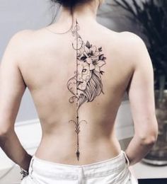 a woman with a lion tattoo on her back