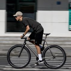 a man riding a bike down the street