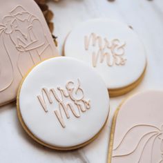 decorated cookies with the word mrs and mr written on them are sitting next to each other