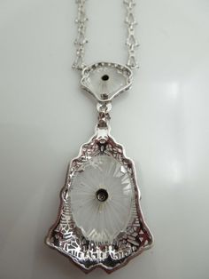 "For Sale: (1) g610 Elegant Ladies 14kt White Gold Diamond Filigree Necklace Pendant PLEASE READ ENTIRE DESCRIPTION BEFORE PURCHASING This is a stunning piece. Set in 14kt white gold, this camphor piece comes attached to the long and short style chain. Centered in the bigger part of the pendant, is a .02ct old mine cut diamond. Perfect for that special occasion. Would be a nice birthday, anniversary, Mother's Day or Valentine's Day gift for her! Specifics: 14kt White Gold Camphor Glass Diamond w Exquisite Hallmarked Diamond Necklace For Formal Occasions, Antique White Gold Necklace With Diamond Accents, Antique Round Necklace With Diamond Accents, Art Deco White Gold Oval Necklace, Antique White Gold Necklace With Filigree, Antique White Gold Necklace With Intricate Design, Antique White Gold Filigree Necklace, Antique White Gold Pendant Necklace, Art Deco Oval Diamond Necklaces