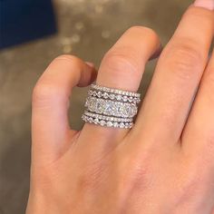 a woman's hand with two rings on it and one is holding the other