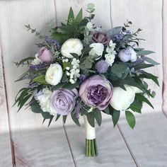 a bridal bouquet with purple and white flowers