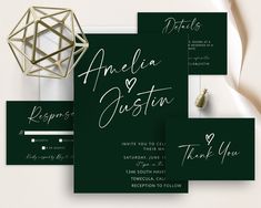 the wedding stationery is set up with green and white cards, envelopes, and thank you notes