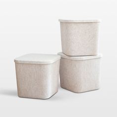 three white containers stacked on top of each other