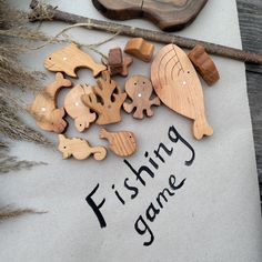 some wooden toys are laying on top of a piece of paper that says fishing game