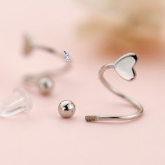 These cute, elegant spiral heart earrings features Valentine heart shape and screw ball back at one end to keep the earrings secured. These cute Valentine spiral heart earrings are comfortable to wear everyday. Add these cute spiral heart earrings to your everyday fine jewelry collection or as gift for your love one. These earrings are made of solid 925 sterling silver with gold plate or platinum plate to create color options. Jewelry Care: See more information about how to care for your jewelry Silver Heart Piercings For Valentine's Day, Adjustable Silver Heart Piercings, For Your Love, Fine Jewelry Collection, Valentine Heart, Heart Earrings, Heart Shape, Solid 925 Sterling Silver, Jewelry Care