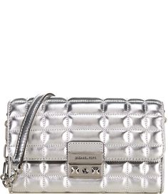 From Michael Kors&#x2C; the Tribeca Large Silver Metallic Leather Convertible Crossbody Bag features:Crossbody bagMetallic leather100% leatherSilver-tone hardwareExterior details: back slip pocketInterior details: back slip pocket&#x2C; 8 card slotsLining: 100% polyesterSnap fasteningApprox. 7.5”W X 4.5”H X 1.25”DRemovable strap approx.: 20.5”Imported. Leather Top Handle Bag With Silver-tone Logo Plaque, Leather Top Handle Shoulder Bag With Silver-tone Logo, Leather Shoulder Bag With Silver-tone Logo, Modern Travel Bags With Silver-tone Logo Plaque, Modern Travel Bag With Silver-tone Logo Plaque, Modern Travel Bag With Silver-tone Logo, Michael Kors Leather Shoulder Bag With Palladium Hardware, Chic Leather Bag With Silver-tone Logo, Chic Rectangular Bags With Silver-tone Logo Plaque