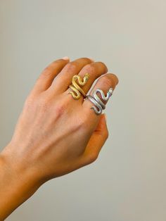 Embrace elegance with our 14K Gold Snake Ring, a stunning blend of mystique and luxury. Whether you prefer the radiant shine of 14K gold plating or the sleek sophistication of sterling silver, this adjustable Snake Wrap Ring is a unique and timeless piece. The design features a coiled snake, symbolizing transformation and power, making it a striking statement accessory. Crafted with meticulous attention to detail, the open style allows for easy adjustment, ensuring a comfortable fit for any fing Luxury Gold Snake Ring With Polished Finish, White Gold Diamond Rings Tarnish Resistant, Luxury Snake-shaped Wedding Ring, Luxury Gold Snake Ring For Anniversary, Yellow Gold Diamond Ring In Snake Shape, Fine Jewelry Silver Snake-shaped Ring, Fine Jewelry Silver Snake Shape Ring, Silver Snake Shape Fine Jewelry Ring, Elegant Silver Snake-shaped Ring