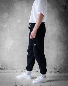 Upgrade your casual wardrobe with the Bregos Men's Black Pants. These versatile pants are perfect for any occasion, offering a blend of comfort and style. Made from 100% premium cotton, they are ultra-soft and breathable, ensuring all-day ease. The elastic waistband with an adjustable drawstring provides a secure and customizable fit. Features include side pockets and a back pocket for convenience, and ribbed cuffs for a modern look. Pre-shrunk so no surprises in the wash, and available in vario Basic Bottoms With Comfort Waistband For Streetwear, Streetwear Bottoms With Comfort Waistband, Ribbed Waistband Trousers For Streetwear, Urban Streetwear Bottoms With Ribbed Waistband, Urban Bottoms With Ribbed Waistband For Streetwear, Baggy Pants With Comfort Waistband For Streetwear, Urban Black Pants With Ribbed Waistband, Tapered Leg Pants With Ribbed Waistband For Streetwear, Black Cotton Pants With Comfort Waistband