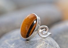 Beautiful natural tiger's eye cabochon, 13 x 18mm. The band is a single piece of solid .925 sterling. This ring is the only one I've made like it. Fast free shipping from Southern California! Returns accepted within 14 days of receiving the item. Brown Sterling Silver Cabochon Ring, Brown Sterling Silver Ring With Cabochon, Sterling Silver Stackable Rings, Stackable Rings Silver, Cheap Rings, Metal Works, Band Photos, Metal Words, Tigers Eye