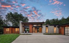 a modern house with two car garages in the driveway