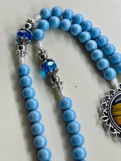 Blue Beaded Rosary As A Gift, Adjustable Blue Beaded Rosary, Blue Beaded Necklaces With 8mm Beads As Gift, Handmade Blue Crucifix Jewelry, Blue 108 Beads Spiritual Rosary, Spiritual Colorful Beads Rosary As Gift, Blue Cross Rosary As Gift, Spiritual Blue Rosary With 108 Beads, Spiritual Rosary With Colorful Beads As Gift