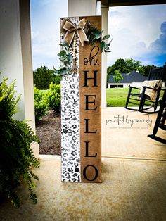 a sign that says oh helo on it with a bow and leopard print ribbon