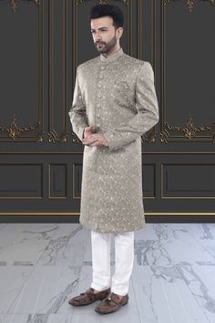 This men's Sherwani, style M42-S135, features exquisite thread embroidery and delicate sequin details. Impeccably crafted, this traditional garment offers a touch of luxury and sophistication to any occasion. Elevate your style with this stunning piece, perfect for weddings or special events. Elegant Sherwani With Zari Work Straight Kurta, Elegant Sherwani With Zari Work, Traditional Silver Kurta With Traditional Drape, Elegant Embroidered Sherwani Straight Kurta, Traditional Silver Kurta With Resham Embroidery, Elegant Embroidered Jamawar Bandhgala, Fitted Silver Kurta For Festive Occasions, Elegant Sherwani With Dabka On Straight Kurta, Formal Straight Kurta Bandhgala With Intricate Embroidery