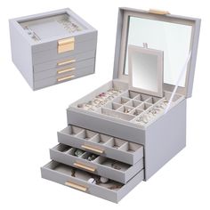 an open jewelry box with three drawers and two mirrors on the top one is empty