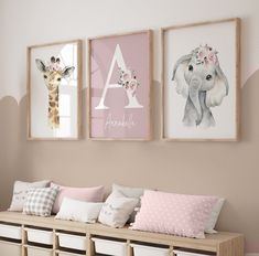 three framed pictures hang on the wall above a wooden bench with storage bins underneath it