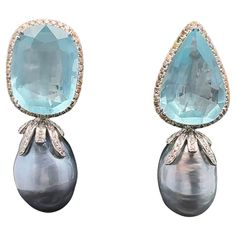 This pair of earrings showcases a stunning combination of elements that make it both fun and elegant. The 18KWG light grey baroque South Sea pearl adds a touch of sophistication, while the pear-shaped and oval aquamarines weighing approximately 32 CTS bring a pop of color and vibrancy. Mixed-color diamonds and white diamonds further enhance the overall appeal of the design. The clip-on and retractable post feature adds a practical and versatile element, ensuring that these earrings are not only stylish but also easy and comfortable to wear. Quick information: Aquamarine - Pear Shape and Oval: total weight is approximately 32.85CTS Diamonds - Round white 40 pcs. : SI2-3 K color - approximately 0.37 CTS Mixed color (yellow, brown, and pink) - SI3 - approximately 1.15 CTS Pearls: Baroque ligh Earring Video, Cocktail Earrings, Golden South Sea Pearls, Aquamarine Earrings, Diamond Dangle Earrings, Pink Morganite, Sea Pearl, Aquamarine Stone, Large Hoop Earrings