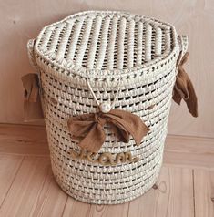 a woven basket sitting on top of a wooden floor