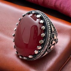 Indulge in the majestic allure of Yemen's renowned Red Agate with our stunning ring, expertly crafted from authentic Yemeni Agate stone and encased in luxurious 925 sterling silver. This commanding ring boasts a generously sized Red Agate stone, showcasing the natural beauty and vibrant hue characteristic of Yemeni Agate. Each stone is a testament to the geological wonders of Yemen, with unique patterns and rich, fiery tones that make it truly one-of-a-kind. Meticulously handcrafted to perfectio Yemen, Red Agate, Agate Ring, Agate Stone, Signet Ring, Unique Patterns, 925 Sterling Silver Ring, Meaningful Gifts, Statement Pieces