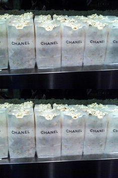 several bags of chanel popcorn are stacked on top of each other