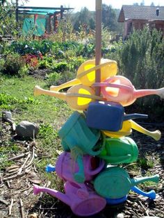 a pile of plastic toys sitting on top of a grass covered field next to a tree