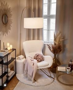 a white chair sitting next to a window in a living room