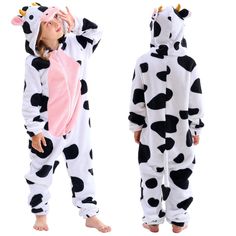 two children in pajamas are dressed up as cows