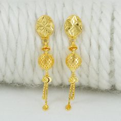 Celebrate the essence of Indian heritage with these radiant 22k gold earrings. Each earring is meticulously designed with traditional patterns that catch the light and add a regal touch to your look. Perfect for both festive occasions and elegant evenings, these earrings are a testament to the rich history of Indian jewelry, offering a blend of classic beauty and modern sophistication. 22k gold earrings handmade jewelry made in India Metal is Real Gold Not Filled or Not Gold Plated Metal - Yello 22k Gold Round Danglers For Gift, Gold Round Danglers As Gift, Gold Round Danglers For Gift, Gold Danglers As Gift, Gold Earrings With Latkans For Gifts, Gold Latkans Earrings For Anniversary, Handmade 22k Gold Dangle Earrings, Handmade Yellow Gold-plated Danglers, Handmade Yellow Gold Plated Danglers