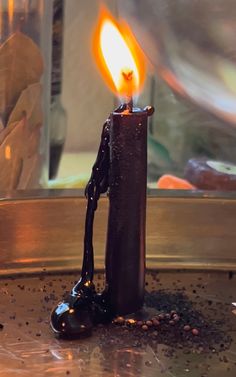 a candle that is on top of some kind of metal thing in the middle of a table