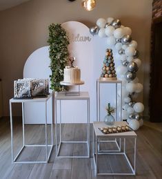 two tables with cakes and balloons on them