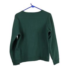 a green sweatshirt hanging on a hanger