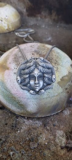 Medusa Head Silver Necklace with Chain, Ancient Greek Mythology Necklace, 925k Sterling Silver Handmade Jewelry, Greek Mythology Pendant 💥Item Details * Gender: Male / Female * Material: 925 Sterling Silver * Pendant Weight: 13 - 15 Grams * Pendant Diameter : 3.00cm x 3.00cm ( 1.18inc x 1.18inc ) * All our products are handmade and weights may vary  (-) 1,00 gram * Chain Length: 18,20,22,24,26,28 Inches ( Contact me if you are expecting to buy another chain  ) Discover unique designs, handcrafted by 7S' s artisans. Artistic hands have added a special spirit to the details. You will find traditional and contemporary styles designed to delight those seeking something different. Handcrafted, Each Gold Plated and 925k Sterling Silver Necklace is a unique piece that is professionally and indiv Silver Spiritual Snake Chain Jewelry, Spiritual Silver Snake Chain Jewelry, Spiritual Sterling Silver Snake Chain Jewelry, Silver Snake Chain Jewelry With Oxidized Finish, Silver Oxidized Snake Chain Jewelry, Silver Oxidized Finish Snake Chain Jewelry, Symbolic Sterling Silver Snake Chain Jewelry, Symbolic Round Pendant Necklace, Mythological Engraved Round Pendant Jewelry