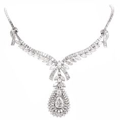 This conspicuous diamond necklace with a detachable pendant is crafted in solid platinum. Depicting romantically designed ribbon 'knots' on both sides, and diamond-studded ribbon ends at the center, this versatile necklace can be worn with or without the pear shape pendant. The latter is set with a combination of marquise and round-faceted diamonds, while the necklace exposes marquise and baguette diamonds. The necklace and the pendant is center with a GIA certified pear-shape diamond approx. 2. Luxury Baguette Diamond Necklace For Evening, Wedding Platinum Marquise Necklace, Platinum Marquise Necklace For Wedding, Luxury Platinum Pear-shaped Necklace, Luxury Evening Necklace With Baguette Diamonds, Luxury Evening Necklaces With Baguette Diamonds, Luxury Baguette Diamond Necklaces For Evening, Diamond White Platinum Diamond Necklace For Evening, Platinum Baguette Cut Diamond Necklace For Wedding