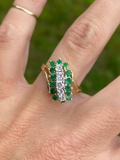 Gorgeous sparkle on this one!   There are approx .30ctw of genuine diamonds H/I1, and approximately .28ctw of genuine round emeralds.   The ring measures 15mm at the widest point and tapers to 2mm in the back. It is stamped for 14K yellow gold. It weighs 5.4g.  Size 6.75 and sizable.  We are happy to offer sizing for an additional charge. Let me know if you need a quote on sizing. Diamond Multi-stone Emerald Ring For May Birthstone, Anniversary May Birthstone Emerald Ring With Single Cut Diamonds, Emerald Pave Setting Ring For Anniversary, Emerald Cluster Ring With Diamonds, Emerald Anniversary Ring With Pave Setting, Green Cluster Diamond Ring For Anniversary, Emerald Ring With Pave Setting For May Birthstone Anniversary, Green Emerald Cluster Ring With Diamonds, Green Emerald Ring With Pave Setting For Anniversary