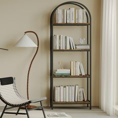 a room with a chair, bookshelf and lamp on the wall next to it