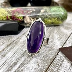 Purple Amethyst Oval Crystal Statement Ring in Sterling Silver - Designed by FOXLARK Collection Photos are an example. Each stone will be different and each ring handcrafted please allow for differences. Ring length approximately 1.5" Ring is sterling silver and adjustable. Adjustable band is thick sterling silver and adjustable part is hidden under the stone. You can easily adjust the size from roughly size 6-9 yourself. We do recommend you adjust it and leave it so as not to weaken the silver Large Oval Amethyst Stone Jewelry, Purple Oval Sterling Silver Crystal Ring, Luxury Polished Amethyst Oval Cabochon Ring, Elegant Silver Amethyst Ring, Oval Cabochon, Purple Amethyst Crystal Ring, Oval Shaped, Co Design, Be Different, Purple Amethyst, Natural Crystals