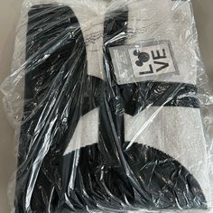 two pieces of black and white clothing wrapped in plastic