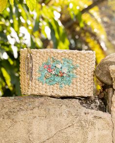 Clutch style bag from woven palm, adorned with sea-inspired embroidery and beading. Dimensions: 9" width, 5.5" height Beige Embroidered Straw Bag For Everyday Use, Embroidered Beige Straw Bag For Travel, Embroidered Rectangular Shoulder Bag For Vacation, Rectangular Embroidered Shoulder Bag For Vacation, Beaded Crochet Rectangular Bag For Beach, Embroidered Natural Straw Travel Bag, Bohemian Beaded Rectangular Beach Bag, Embroidered Rectangular Vacation Bag, Embroidered Rectangular Straw Bag For Beach