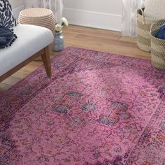 a living room area with a couch, chair and rug