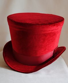 The Dandy is a simple and yet elegant victorian inspired top hat.It is covered with soft rich velvet in wine red.It is elegantly embellished with matching colored ribbon around the crown. Available in black, red(pictured) or ivory with matching ribbon. Need this TOP HAT in another color? with more decoration? Just send me a message to talk about a custom hat made just for you! This hat is fully lined with satin and it is made to according to your exact head measurement making it suitable for bot Fitted Brimmed Top Hat For Themed Events, Red Brimmed Hat For Costume, Red Costume Hat, Fitted Red Halloween Hat, Red Fitted Hat For Costume, Red Fitted Vintage Top Hat, Vintage Red Hat For Costume Party, Vintage Red Hats For Costume Party, Classic Red Fitted Top Hat